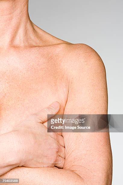 woman covering her breast - lentigo stock pictures, royalty-free photos & images