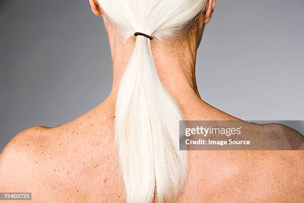 senior woman with ponytail - liver spot stock pictures, royalty-free photos & images