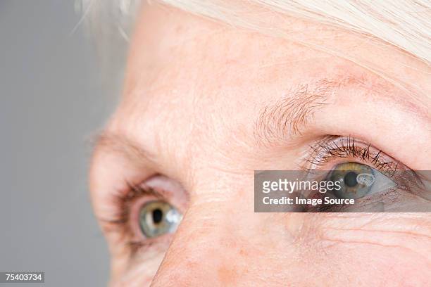 eyes of a senior woman - human eye stockfoto's en -beelden