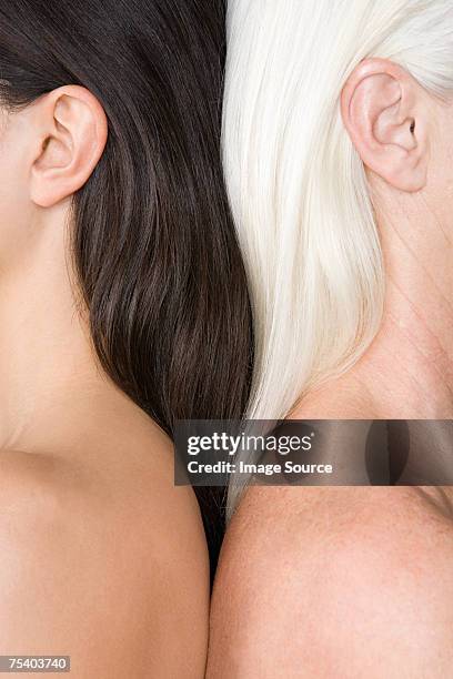 women with dark and light hair - human ear stockfoto's en -beelden