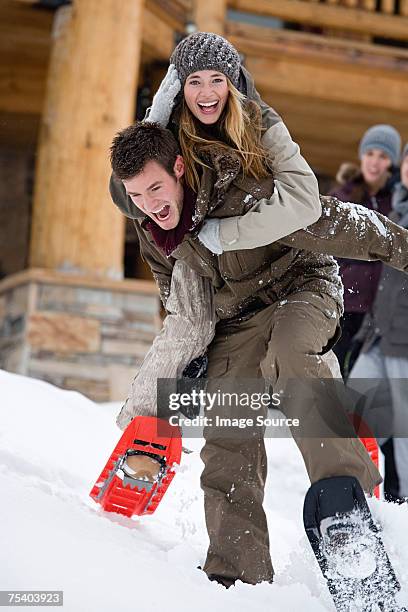 couple having fun in the snow - skiing and snowboarding stockfoto's en -beelden