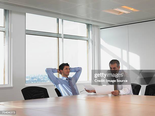 men in meeting room - arrogance stock pictures, royalty-free photos & images