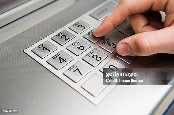 person pressing cash machine keypad - entering pin stock pictures, royalty-free photos & images