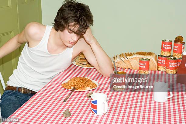 tired teenager at table - baked beans stock pictures, royalty-free photos & images