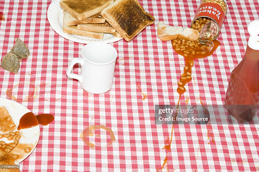 Baked beans spilt on tablecloth