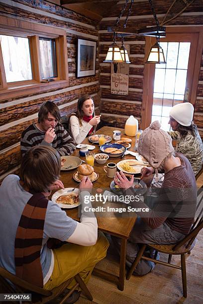 friends having breakfast in chalet - winter breakfast stock pictures, royalty-free photos & images