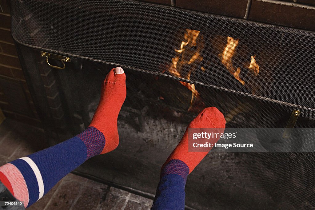 Feet of person by fire