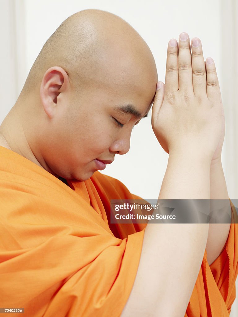 Buddhist man praying