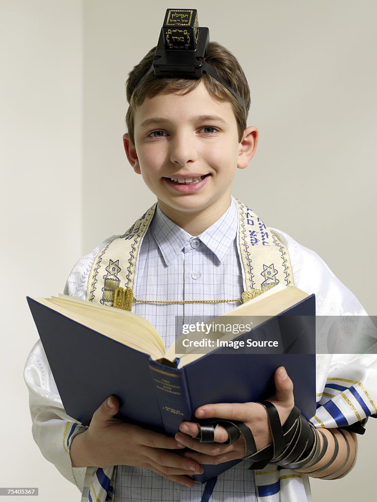 Jewish boy reading from siddur