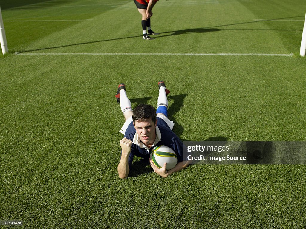 Rugby player scoring a try