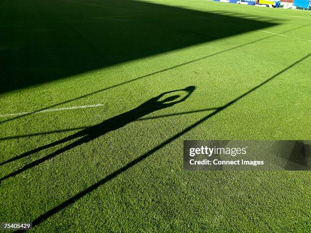 shadow of rugby player and rugby post - rugby post stock pictures, royalty-free photos & images