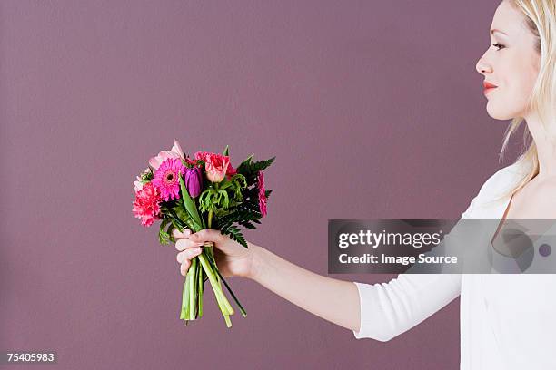 young woman giving flowers - gerbera daisy stock pictures, royalty-free photos & images