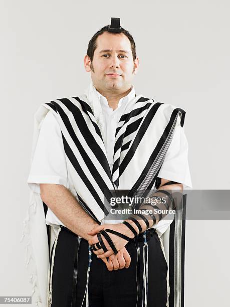 jewish man wearing tallit and teffillin for prayers - jewish prayer shawl stock pictures, royalty-free photos & images