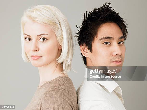 couple back to back - two people plain background stock pictures, royalty-free photos & images