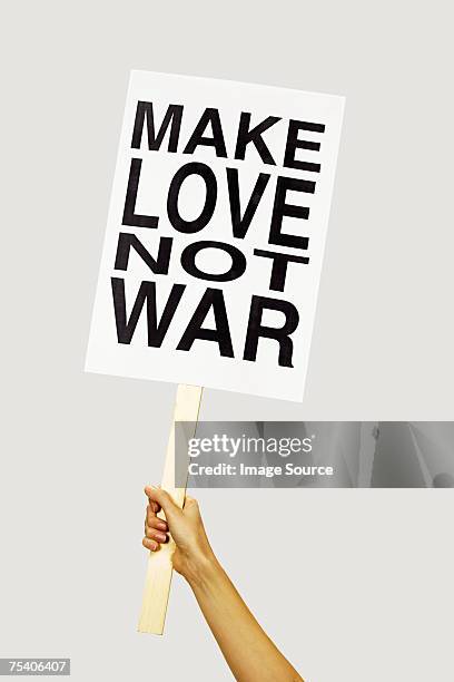 person holding placard - protest stock pictures, royalty-free photos & images