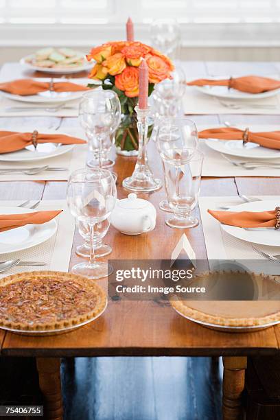 pecan and pumpkin pie on dining table - rose arrangement stock pictures, royalty-free photos & images