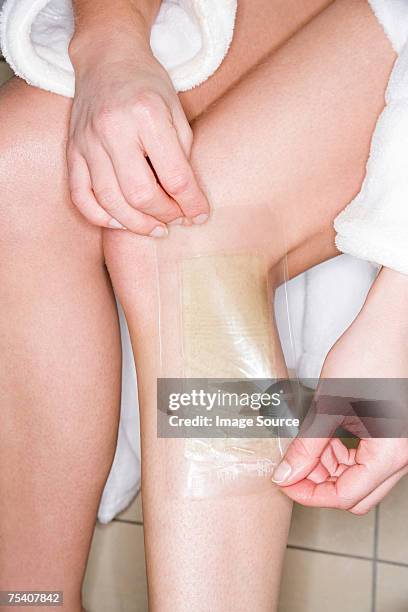 woman waxing leg - leg waxing stock pictures, royalty-free photos & images