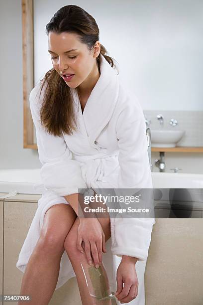 woman waxing leg - leg waxing stock pictures, royalty-free photos & images