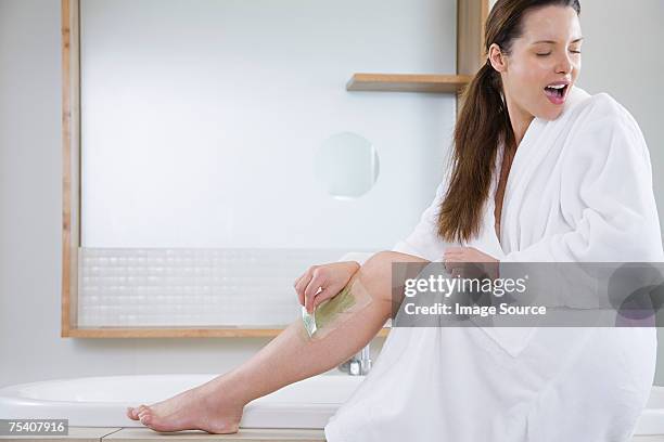 woman waxing leg - leg waxing stock pictures, royalty-free photos & images