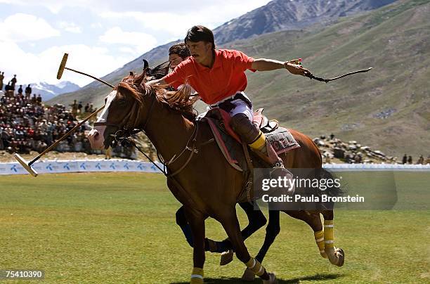 Polo team players Chitral and Gilgit charge down the field during the annual Shandur Polo Festival, July 8, 2007 on Shandur pass in Pakistan. The...