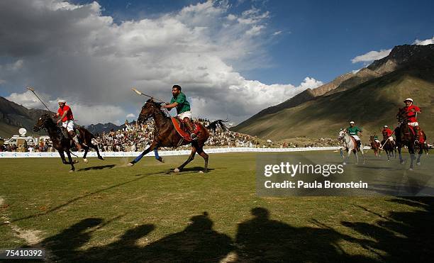 Polo team players Chitral and Gilgit charge down the field during the annual Shandur Polo Festival, July 8, 2007 on Shandur pass in Pakistan. The...