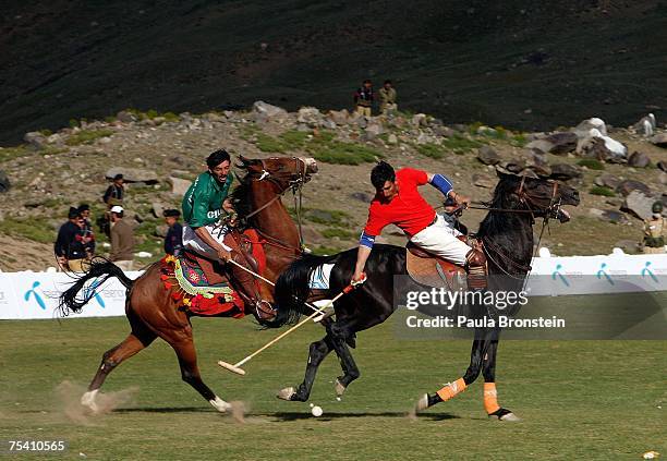 Polo team players Chitral and Gilgit charge down the field during the annual Shandur Polo Festival, July 8, 2007 on Shandur pass in Pakistan. The...