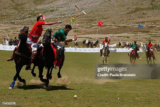Polo team players Chitral and Gilgit charge down the field during the annual Shandur Polo Festival, July 8, 2007 on Shandur pass in Pakistan. The...