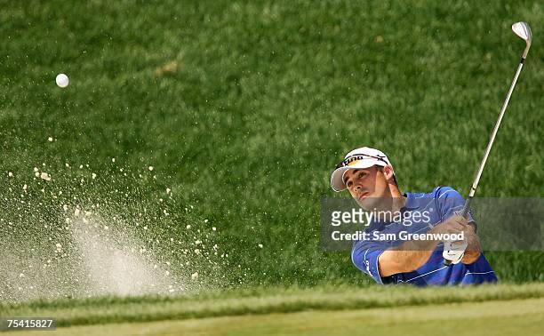 Jonathan Byrd blasts from the bunker on the 14th hole during the third round of the John Deere Classic at the TPC Deere Run July 14, 2007 in Silvis,...