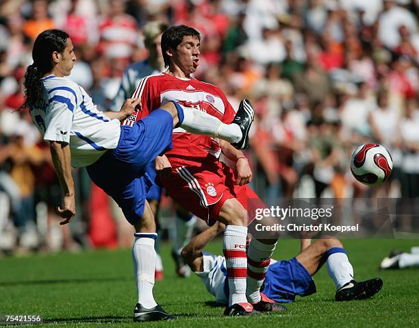 Savas Yesilelma of Albstadt tackles Jose Ernesto Sosa of Bayern Munich during the friendly match between FC Albstadt and Bayern Munich at the...