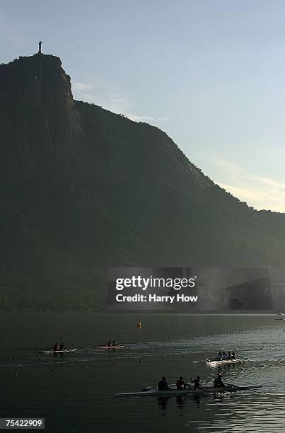 Rowers warm up in front of Cristo Redentor during the 2007 Pan American Games rowing competition at the Estadio de Remo on July 14, 2007 in Rio de...