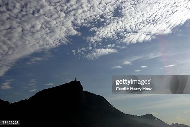 The Christ the Redeemer statue is seen atop Corcovado Mountain during the Lightweight Men's Double Sculls rowing competition at the 2007 XV Pan...