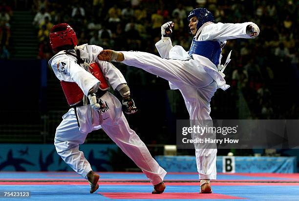 Marcio Ferreira of Brazil kicks Gabriel Mercedes of the Dominican Republic to the mat during their match in the Taekwondo men's 58kg final of the...