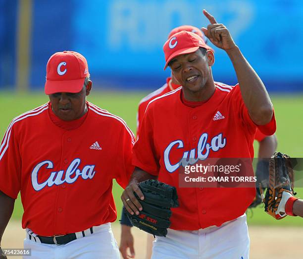 Rio de Janeiro, BRAZIL: Cuban winner pitcher Adiel Palma leaves the field with team manager Vicente Anglada in the seventh inning of the first round...
