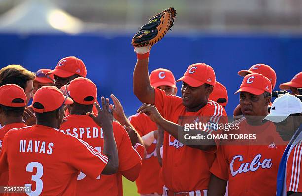 Rio de Janeiro, BRAZIL: Cuban players celebrate in the end of the first round of the baseball game against Mexico at the Cidade do Rock stadium, 15...