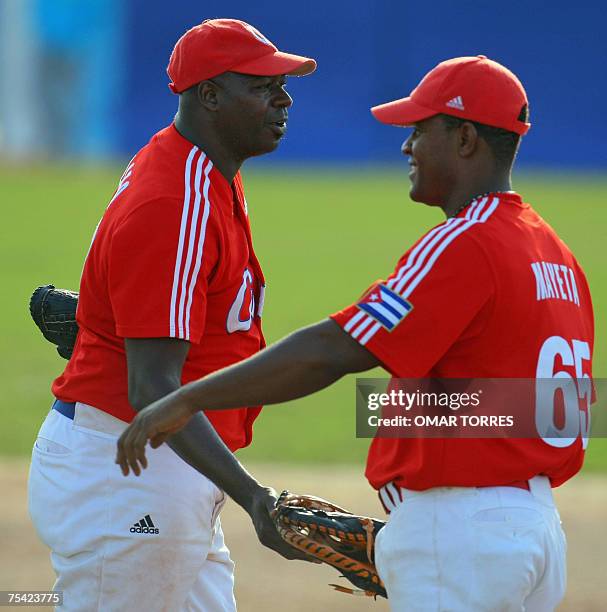 Rio de Janeiro, BRAZIL: Cuban baseball closer pitcher Luis Lazo celebrates with first base Alexander Mayeta at the end of the first round baseball...