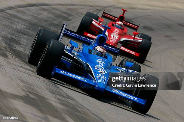 Scott Dixon, driver of the Target Chip Ganassi Racing Dallara Honda, leads Dan Wheldon driver of the Target Chip Ganassi Racing Dallara Honda, the...