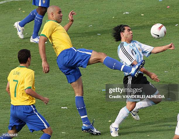 Argentina's Carlos Tevez vies for the ball with forward Alex of Brazil as teammate Elano looks on, during their Copa America-Venezuela 2007 final...