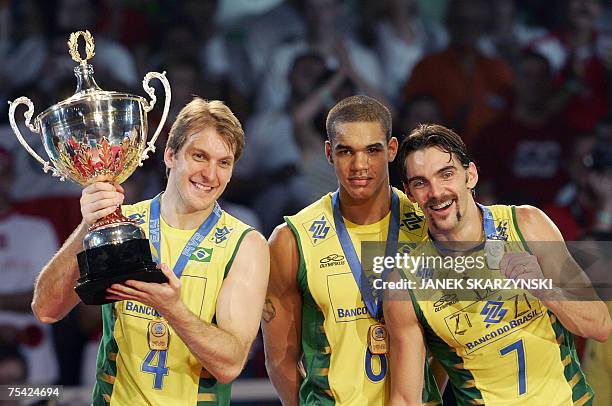 Brazil's Andre Heller,Samuel Fuchs and Giba enjoy with a trophy after winning a World League Final Round 2007 15 July 2007 in Katowice. Brazil won a...