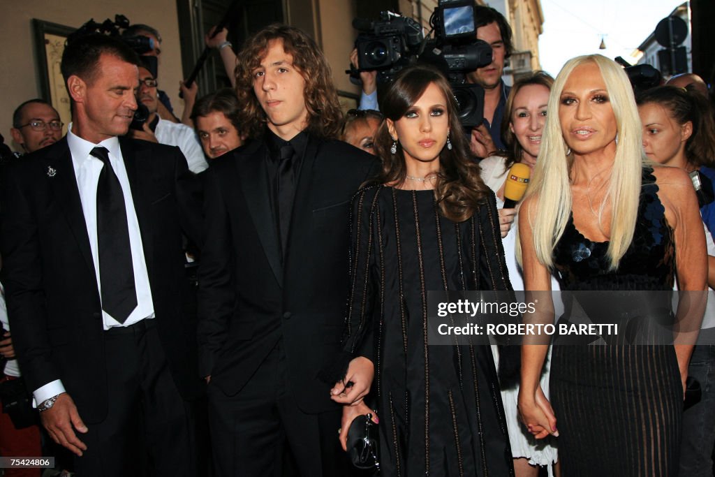 Italian designer Donatella Versace (R) h...