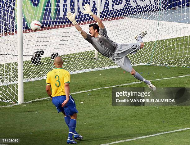 Brazil's goalkeeper Doni dives trying to stop the ball while Alex looks on during the final Copa America Venezuela 2007 match against Argentina, 15...