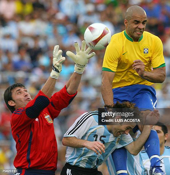 Argentina's goalie Roberto Abondanzieri tries to catch the ball next to teammate Gabriel Milito and Brazil's Alex during their Copa America...