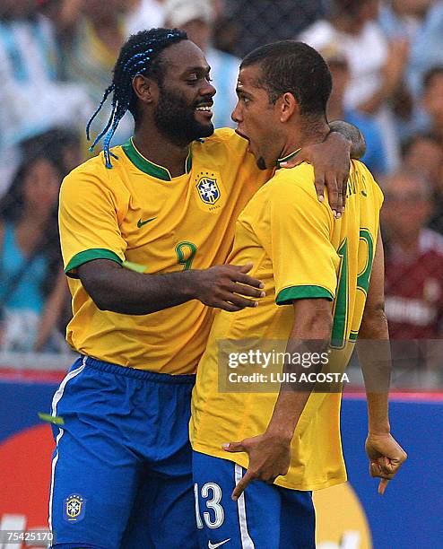Brazil's Daniel Alvez celebrates with his teammate Vagner Love after scoring the third goal against Argentina during their Copa America Venezuela...