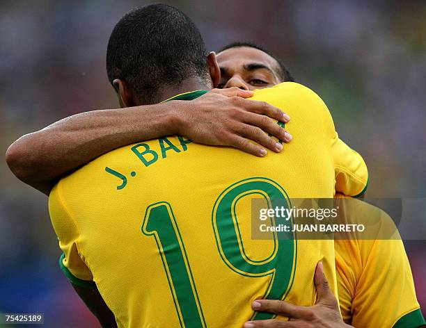Brazil's defender Daniel Alves and midfielder Julio Baptista celebrate the third goal against Argentina during their Copa America 2007 final match,...