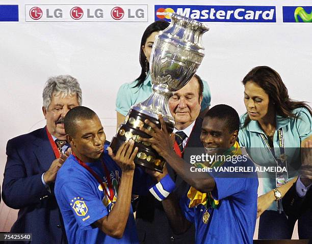 Brazilian players Gilberto Silva and Juan raise the trophy after Brazil won the Copa America 2007 final match against Argentina at the Pachencho...