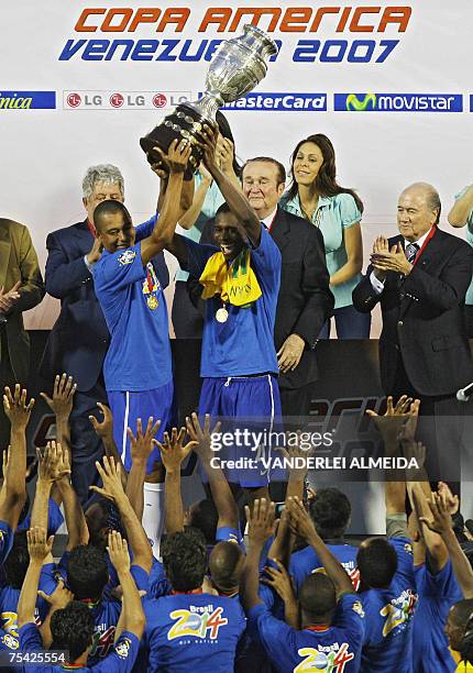 Brazilian players Gilberto Silva and Juan raise the trophy at the end of the Copa America final football match against Argentina at Pachencho Romero...