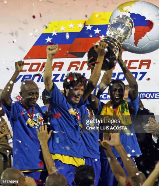 Brazil's players raise the trophy during the Copa America 2007 award ceremony after defeating Argentina by 3-0 in the final match at Pachencho Romero...
