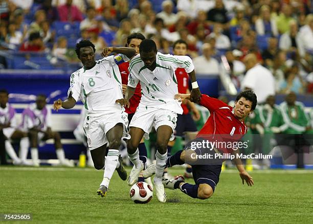 Chukwuma Akabueze of Nigeria throws down Gary Medel of Chile while trying to steal the ball during the Quarterfinal match of the FIFA U-20 2007 World...