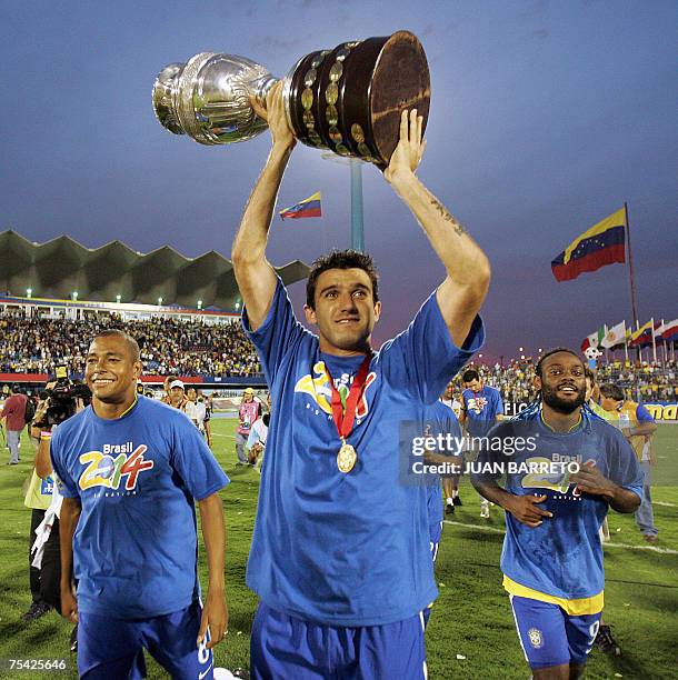 Brazilian midfielder Gilberto Silva, defender Elano and forward Vagner Love celebrate with the trophy after Brazil won the Copa America 2007 final...