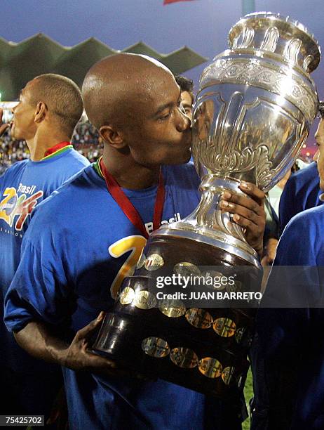 Brazilian midfielder Gilberto Silva kisses the trophy after their victory against Argentina at the end of the Copa America Venezuela-2007 final match...