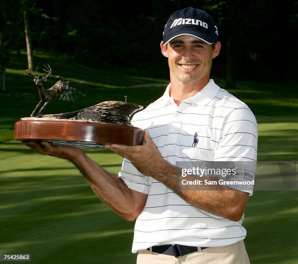 Jonathan Byrd holds the trophy after winning the John Deere Classic at the TPC Deere Run July 15, 2007 in Silvis, Illinois.